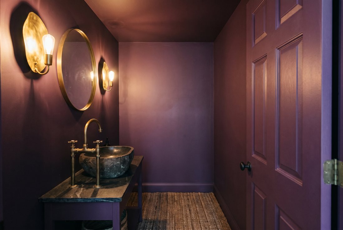 A powder room drenched in deep plum