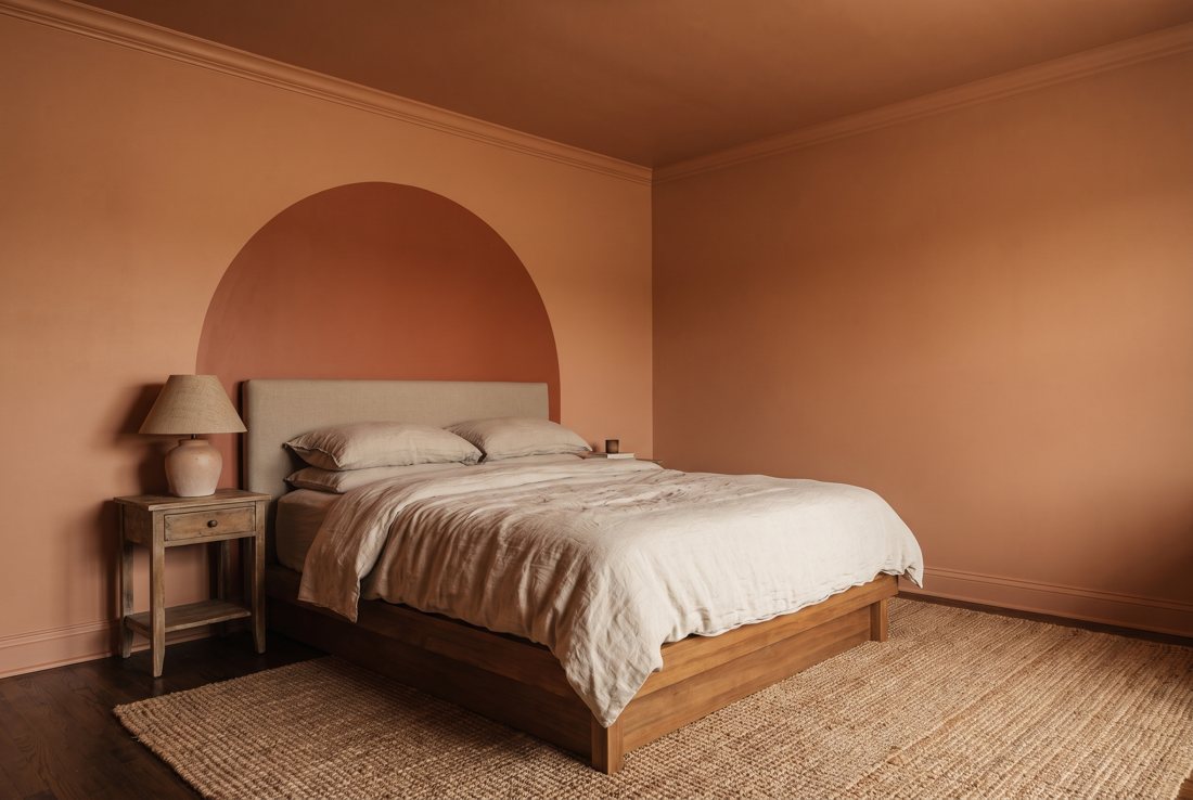 A bedroom drenched in warm terracotta